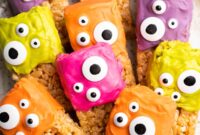 Halloween Rice Krispie Treats, topped with colored icing and candy eyes.