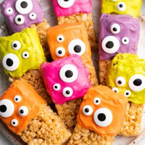 Halloween Rice Krispie Treats, topped with colored icing and candy eyes.