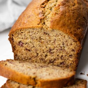 Sliced banana bread on a white table.